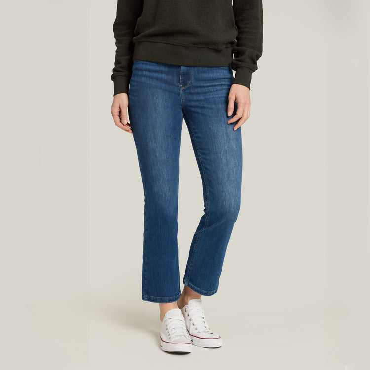 Women wearing Medium Blue High Rise Miniboot Ankle Logan Jeans