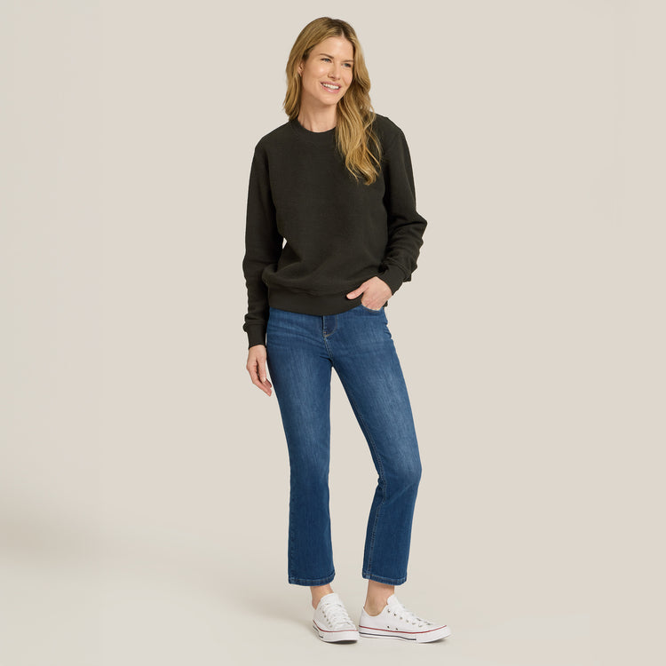 Women wearing Medium Blue High Rise Miniboot Ankle Logan Jeans