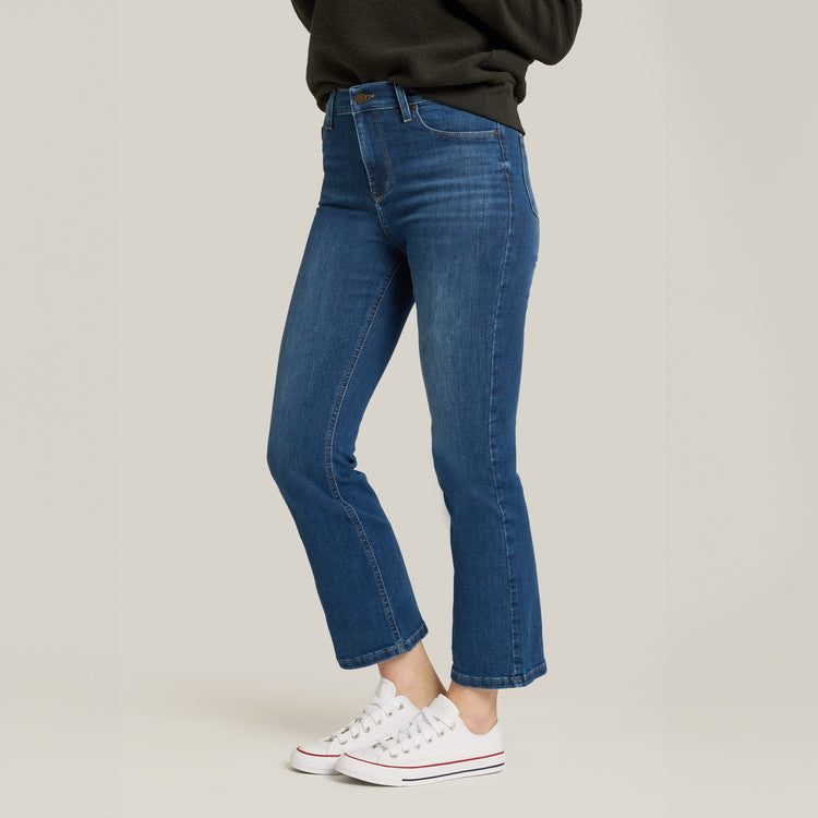 Women wearing Medium Blue High Rise Miniboot Ankle Logan Jeans