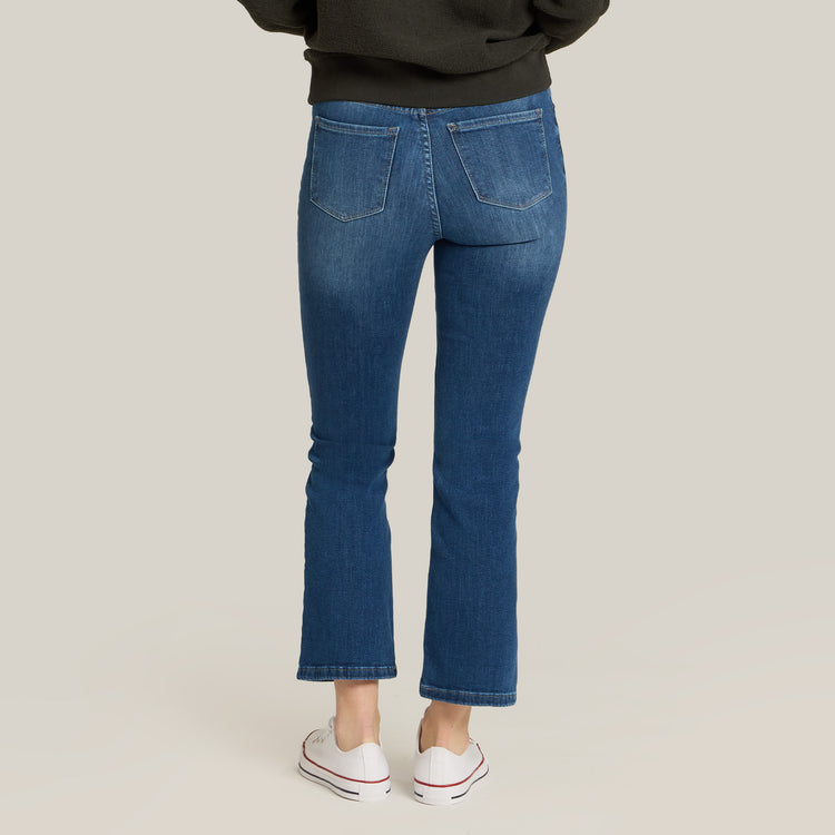 Women wearing Medium Blue High Rise Miniboot Ankle Logan Jeans