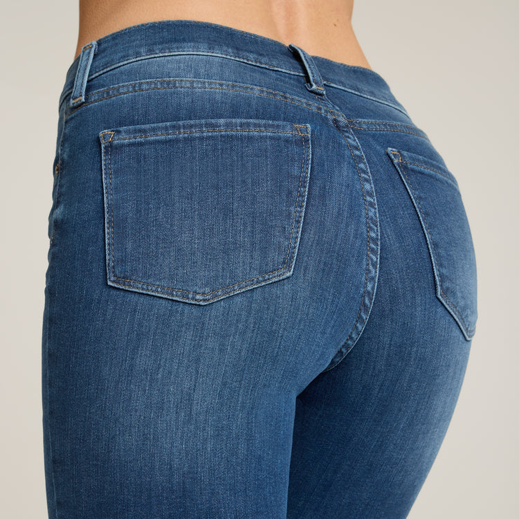 Women wearing Medium Blue High Rise Miniboot Ankle Logan Jeans